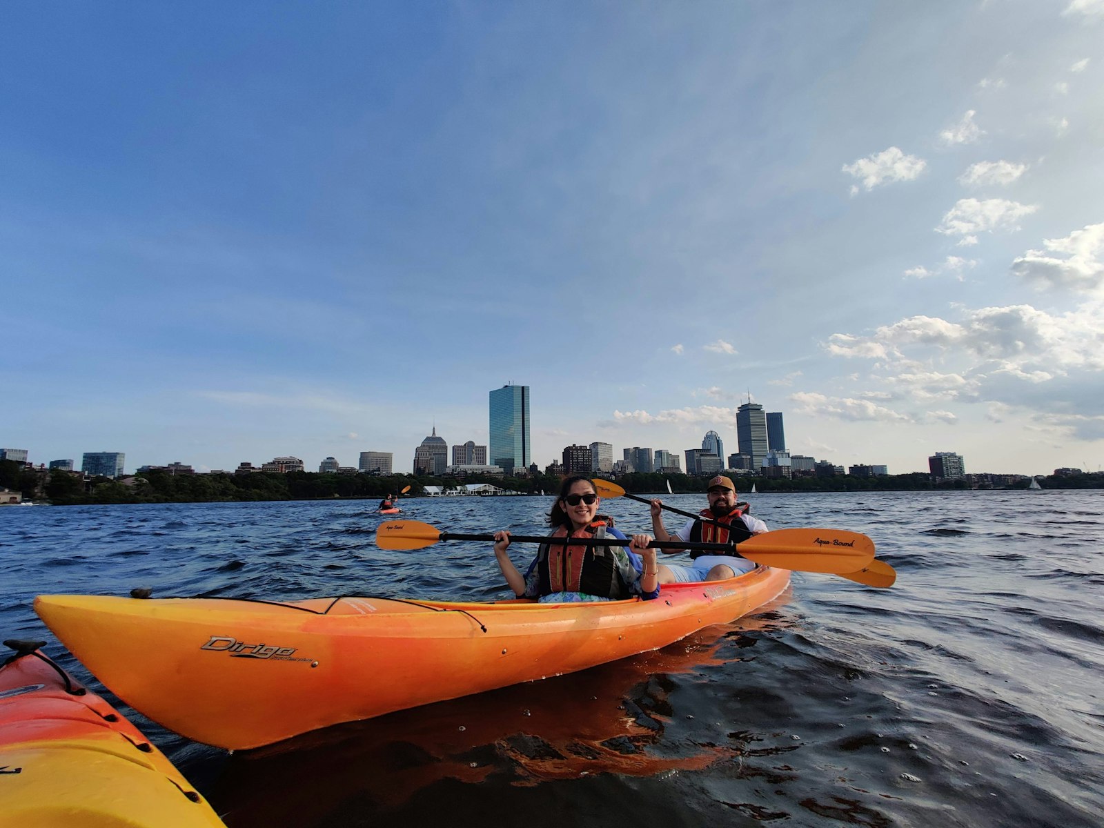 Frank kayaking with the city skyline in the background